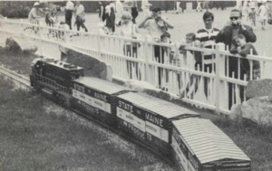 The train, which runs on an oval track both inside and outside the pavilion, attracts both old and young, left, who often climb the fence for a better view.