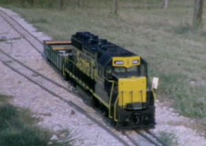 Koster's SD-40 Number 3455 on its way to be delivered to Seymour F. Johnson in California, posing here at Terry McGrath's Annetta Valley & Western Railroad just outside of Fort Worth, Texas. Photo from 8mm movie taken by Bill Koster, mid to late 1970s.
