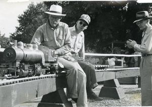 At GGLS--Redwood Regional Park--Oakland with uncompleted 1" 0-6-0 SP switch engine. Larry Duggan riding behind the engineer. Larry was the Founder of the GGLS newsletter, "The Callboy". Photo provided by Ken Shattock.