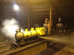 Kari Wirth at the engine shed of HALS, blowing down her Mogul. This locomotive belonged to her grandfather, Harry Simpson, and was blue when he ran it. It was built by Harold Christensen. Photo by Daris A Nevil, May 2013.