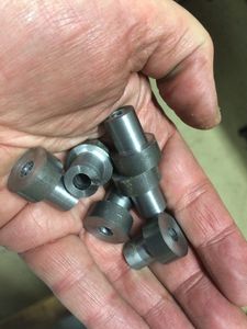 A handful of newly turned motor mount bushings. A total of 16 bushings were required.