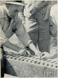 Vic Shattock and Walter Brown spiking rail. Aluminum rails are spiked down on eight-inch wood ties. Continuous 30-inch-high, 1,331-foot-long trestle is made of old railroad bridge ties, donated by Southern Pacific, resting on 147 piers.