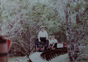 Cliff Pettis routing the trestle at Henry Blossom's track at Wimberley, Texas. Ces Beck is the first passenger behind Cliff. Photo by Pete & Donna Green.