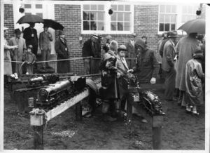 Charlie Purinton is the young man on the right in the group of three boys look at the locomotive.