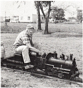 Ces Beck at the throttle of his "Butane Flash" switcher waits on the lead track at Falfurrias, Texas during the First Texas Live Steam Meet.