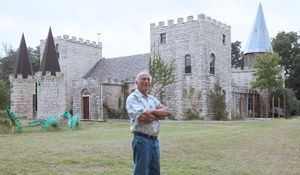 John Greiner stands in front of his home, a castle he built in rural Milam County. Photos by Rusty Schramm.
