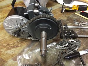 Assembling the #25 chain on the sprocket and motor. This step is performed after attaching the motor to the bearing blocks using four motor mount bushings and four M6-1.00 x 40 hex cap bolts.