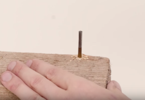 Leave the drill bit embedded in the wood block.