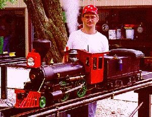 Bill Oberpriller's first steam locomotive, a 2x size Raritan. Ray Heaton III stands next to the locomotive.