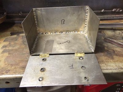 The box was welded together using "stitch" welds to prevent warping. Small brass hinges from Hobby Lobby are riveted to the box and faceplate using 3/32 inch aluminum rivets.