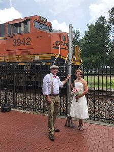 Scott and Cindy Weatherford pose in front of BNSF 3942.jpg