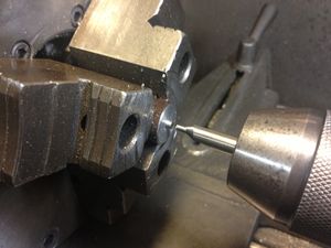 The 3/4 inch part is turned around in the three jaw chuck in order to turn the opposite face. The part is turned to 0.5 inches long. A center point is drilled in the part with a #4 HRS center drill