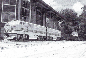 A passenger train powered by an EMD F-7 diesel at Browning Station. The engine was built by Don Phillips of Backyard Rails.