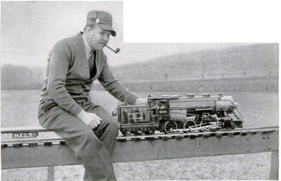 Lester Friend, organizer of the National Association, ready for a ride around the 620-foot loop maintained by the New England club at Danvers, Mass. He is sitting on a flat car.
