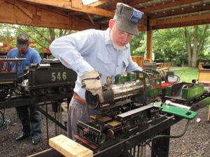 Bob Blackson shown setting the removable boiler on this 1-inch scale live steam locomotive. The loco was built by George Thomas in 1966. Photo by Bill Shields.