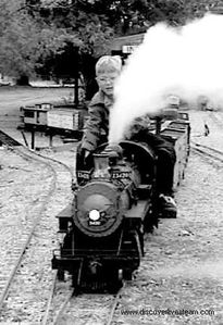 Seven-year-old Garrett at the throttle of his grandfather's (Harry "Scorcher" Bean) 1.5-inch Southern Pacific consolidation #3420X pulling out of the Indian Gap yard on the Comanche & Indian Gap Railroad in 2001. From DiscoverLiveSteam.com