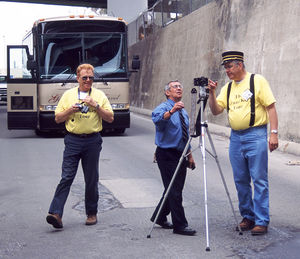 It's JUNE-2002 in Oakland, CA and John Stashik, left, and "Key Route Ken" (Ken Shattock) at far right, discuss trip plans with bus driver Warner Vargas. "The Grand Key Tour" was a chartered bus tour of the former Key System, Sacramento Northern and IER interurban systems in the SF Bay Area. All of us "traction buffs" had a great day !!