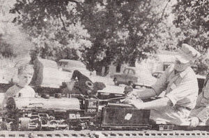 Dave Mackie of Ashland, Wisconsin running his Mikado, with Larry Edwards, of Green Bay, Wisconsin as a passenger, at the Winnipeg Meet in September 1955. The 2599 is scaled 3/4 inch to 1 foot. Not a casting is used in the entire engine. Everything is either fabricated or cut from solid. It has Young valve gear. From The North American Live Steamer, Volume 1, Number 9, 1956.