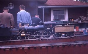 Al Milburn's No 870 4-4-0 in 1 inch scale. Note that Brenton Barnfather's tote box is in the background. Photo was taken May 1961 at unknown location.
