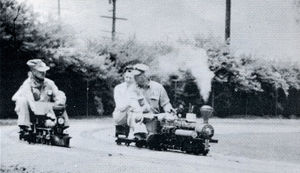 Mark Piper and his 1-1/2 inch scale Early American coming alongside Gordon Corwin at the throttle of his narrow gauge 1-1/2 inch scale Shay Engine at the Los Angeles Live Steamers Golden Spike ceremony, May 5, 1957.