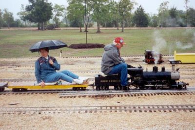 Naomi Sumrall under the umbrella behind Jack Lucks. At the Houston Area Live Steamers, October 2000.