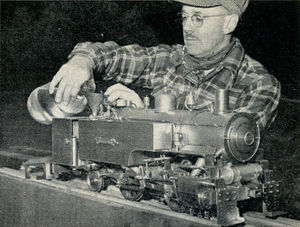 Most models are reproductions, but this dock-side switcher is an original design by Walter Brown, shown here preparing for a run. It weighs 100 pounds, burns wood alcohol instead of coal.