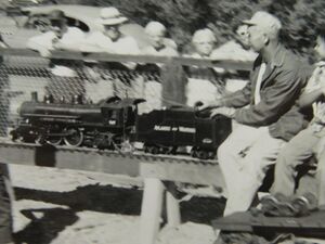Unidentified engineer on a 1 inch scale Atlantic at GGLS Redwood Park in September 1960. Writing on the back reads "This is the engine Pat had to ride on".