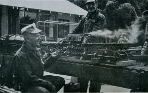Gordon Corwin of Southern California Live Steamers at the Golden Gate Live Steamers Spring Meet, 1956, feeding steam from his locomotive to the engine of his Shay with the able assistance of Louis Lawrence. Photo by Harry Dixon. From The North American Live Steamer, Vol 1 No 5, 1956.
