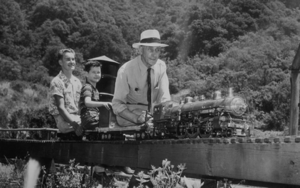 Volunteer "Conductor" Victor Shattock, shown in 1953 with grandsons Kenneth and James Shattock, get ready for an "at speed" run on the Golden Gate Live Steamers layout at Redwood Regional Park on a gleaming 4-6-2 wheel arrangement miniature steam locomotive.