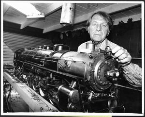 Composer-conductor David Rose works on one of his 16 running steam locomotives at his home, all of them scaled replicas of famous old engines. Rose owns one of the most extensive collections of miniature steam locomotives in the United States. A miniature railroad circumscribes his house and property. Photo by UPI, taken 4 August 1978 in Hollywood, California.