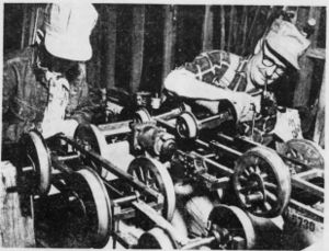 Backshop division of the Raccoon Gulch Lines is the Adams garage where, right, Gordon Adams works on the underframe for a live steam locomotive and left, Sellar Nugent works on his future gasoline-powered engine.