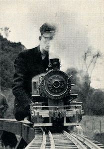Walter Brown at the throttle of live steamer. Special four-rail track takes three gauges of locomotives - 2-1/2-inch gauge for 1/2-inch-to-the-foot scale; 3-1/2-inch gauge for 3/4-inch scale; and 4-3/4-inch gauge for the big one-inchers.