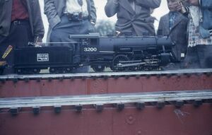 ID006: Unknown location, locomotive and people. From eBay, August 2020. Seller stated the slide had red border, placing its date in the 1950's.