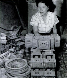 Locomotives in the rough: This stockpile of castings surrounding Mrs. Lewis is drawn on to make up kits for model railroaders the world over and to fill orders for individual parts. From "Popular Science", January 1956