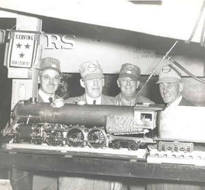 Victor Shattock's basement, 1950. Left to Right: Harry Dixon, Tim Reardon, Al Forst, Vic Shattock. The loco is Tim's 3/4" scale 4-6-4 Hudson.