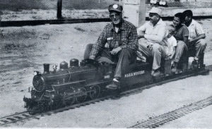 Harry Dixon driving Ray Giffords' 1-1/2 inch scale 10 wheeler at Los Angeles Live Steamers Golden Spike ceremony, May 5, 1957.