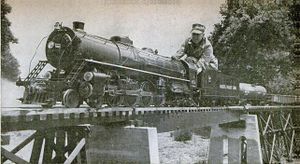 Well-built trestle carries Johnson and his big-model live steamer over picturesque section of his railroad