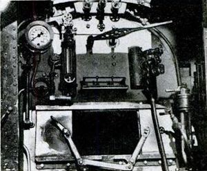 More precise detail is seen inside cab. Lever next to the sight glass is the throttle.