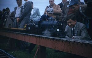 Unknown location, locomotive and people. From eBay, August 2020. Seller stated the slide had red border, placing its date in the 1950's.